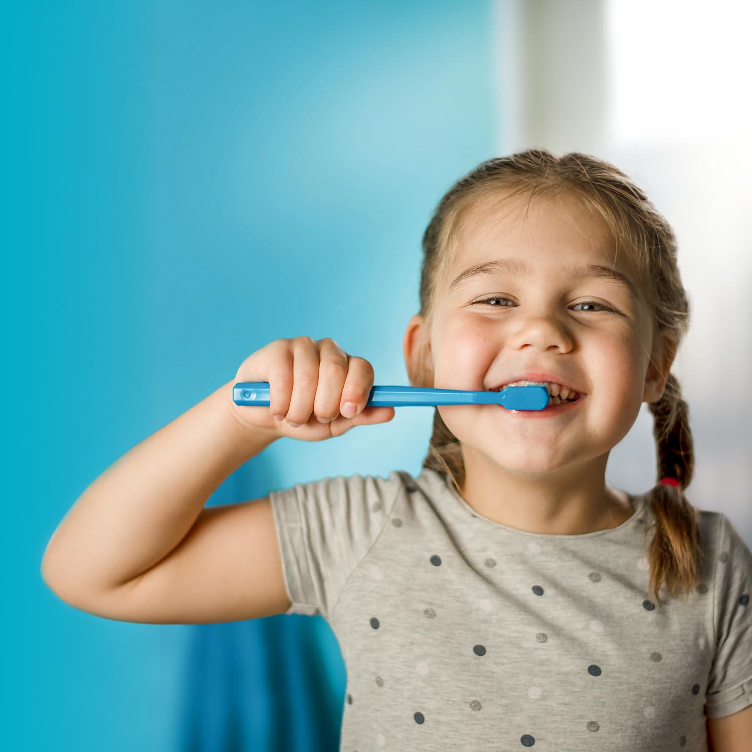 little girl brushing teeth after her dental exams and cleanings